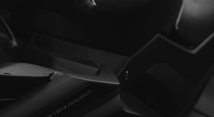 Close-up grayscale shot of a Yamaha motorcycle showcasing its emblem and design.